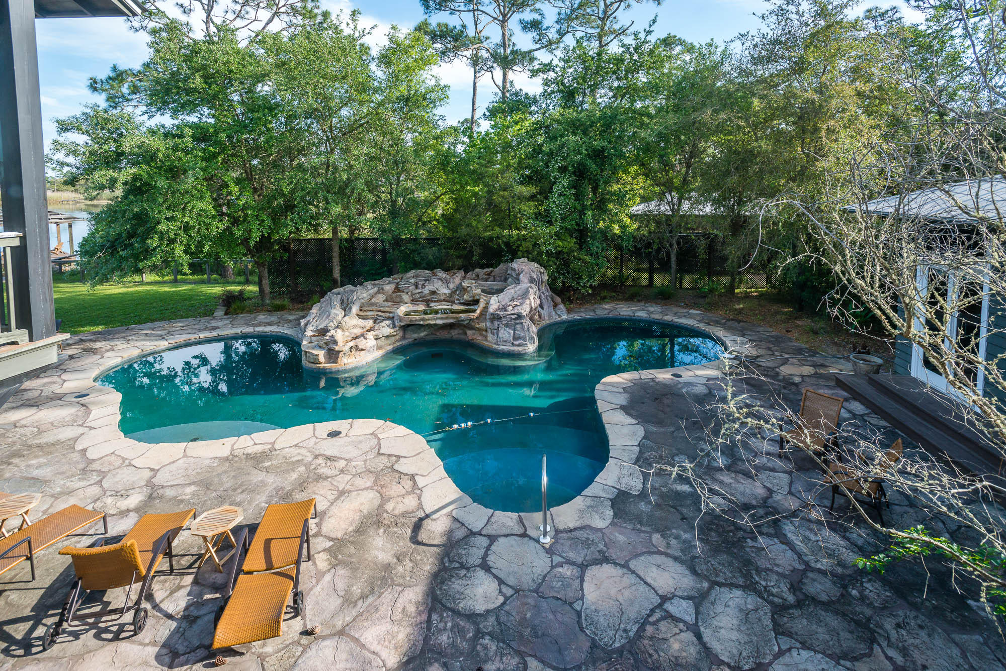 279 Grayton Trail Road Santa Rosa Beach, FL 32459 - Photo 26 of 55 a view of a backyard with table and chairs potted plants and large tree