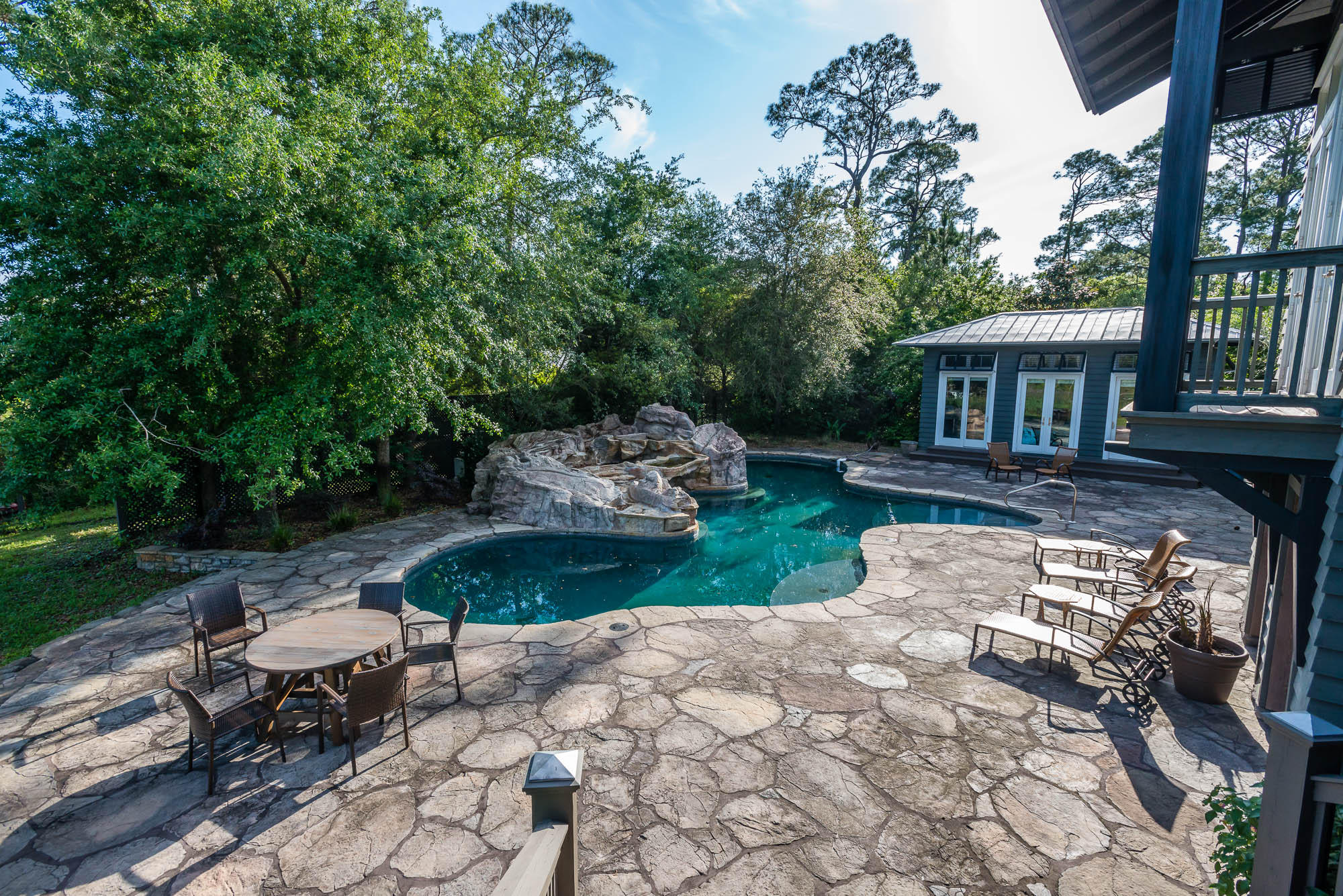 279 Grayton Trail Road Santa Rosa Beach, FL 32459 - Photo 27 of 55 a view of a backyard with table and chairs potted plants and large tree