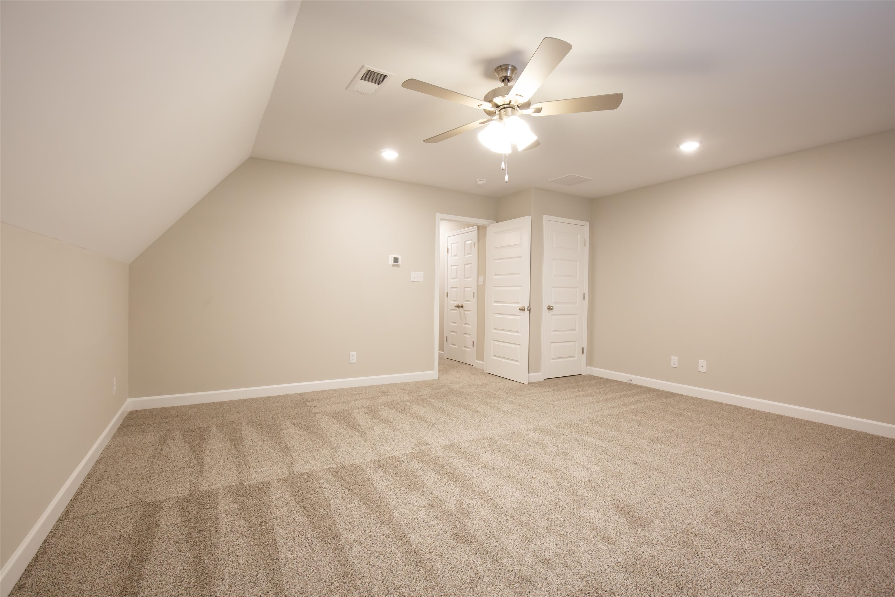 8763 Shipp Road Millington, TN 38053 - Photo 8 of 9 Unfurnished bedroom featuring light carpet, lofted ceiling, visible vents, and recessed lighting