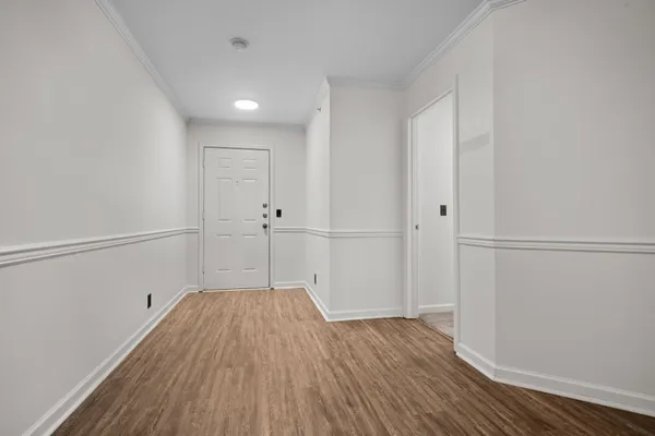 a view of a hallway with wooden floor