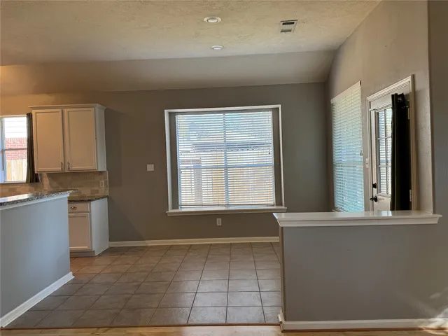 a view of a kitchen with a sink and a window