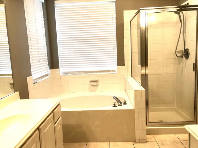 a bathroom with a bathtub and shower