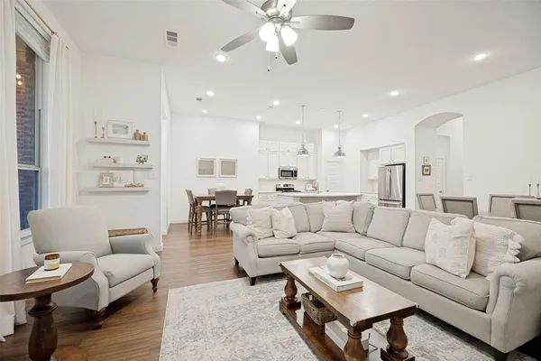 a living room with furniture kitchen view and a table