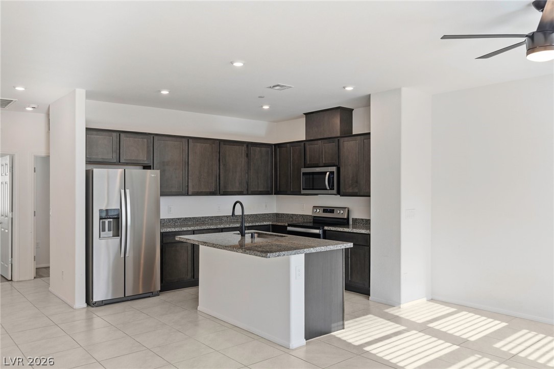 6227 Runestone Street Las Vegas, NV 89113 - Photo 20 of 33 This modern kitchen features a spacious island and sleek appliances, perfect for everyday living.