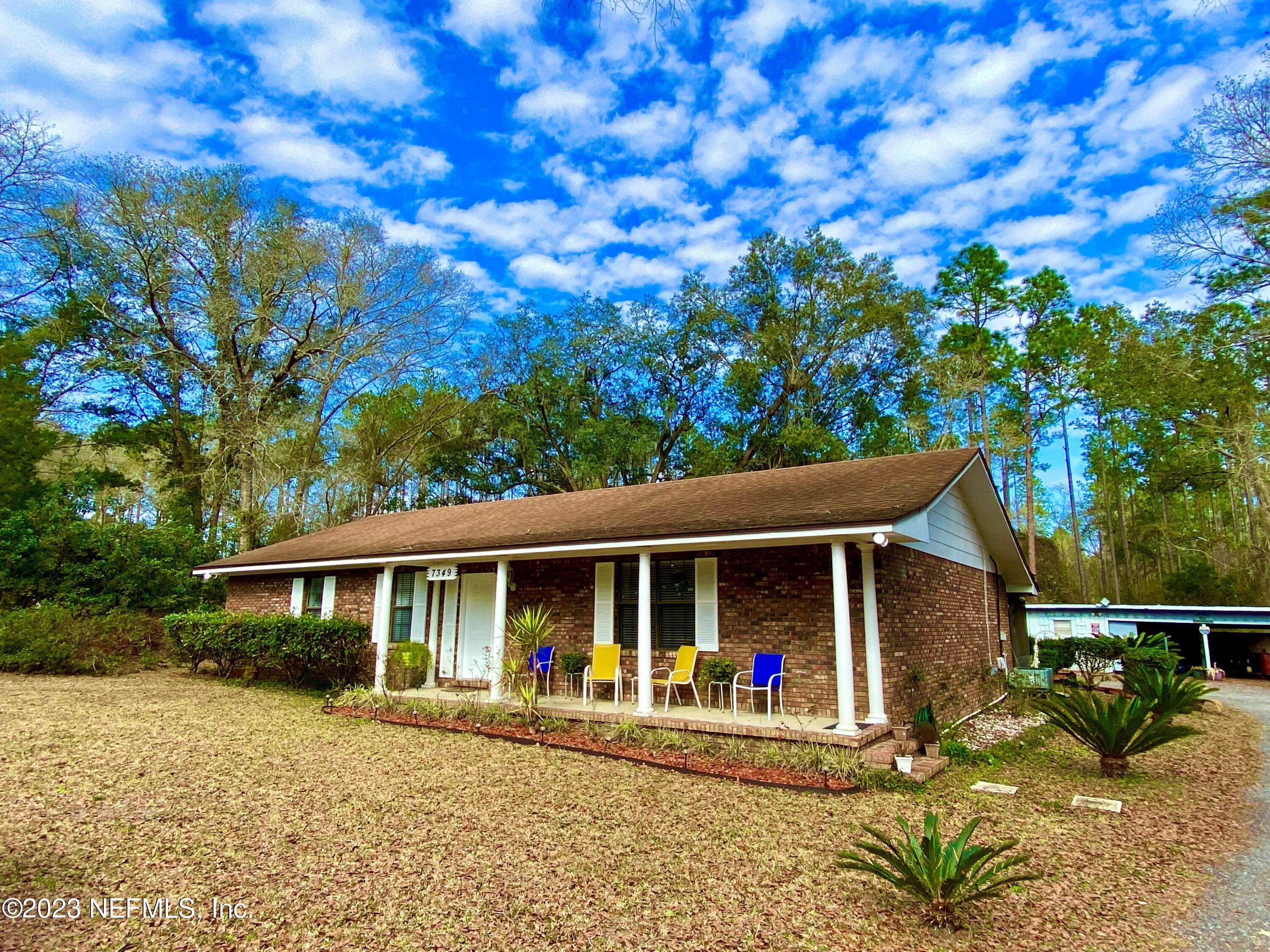 7349 Oakridge Loop Glen St. Mary, FL 32040 - Photo 1 of 56 a front view of a house with porch