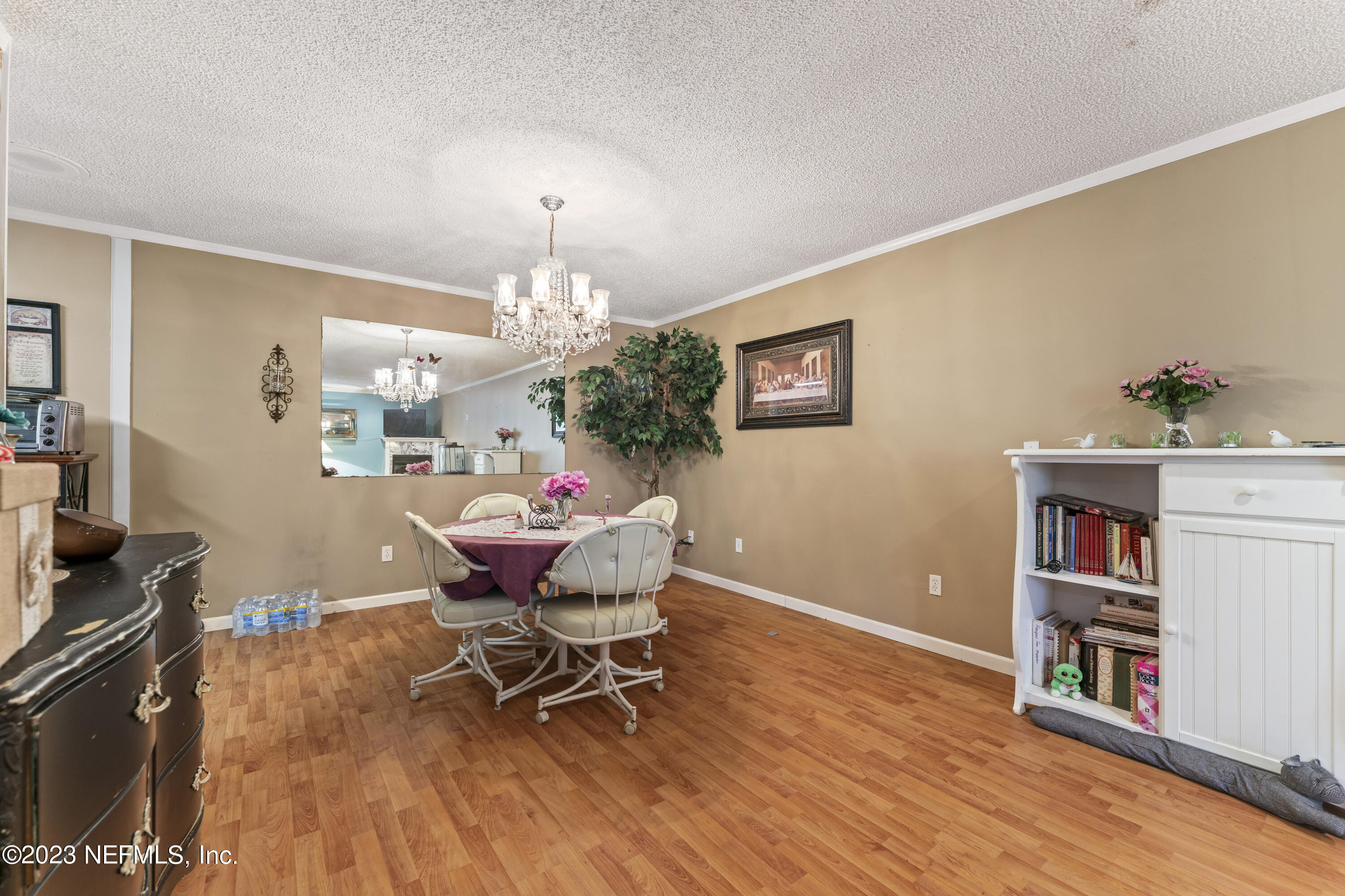 7349 Oakridge Loop Glen St. Mary, FL 32040 - Photo 17 of 56 a dining room with furniture and chandelier