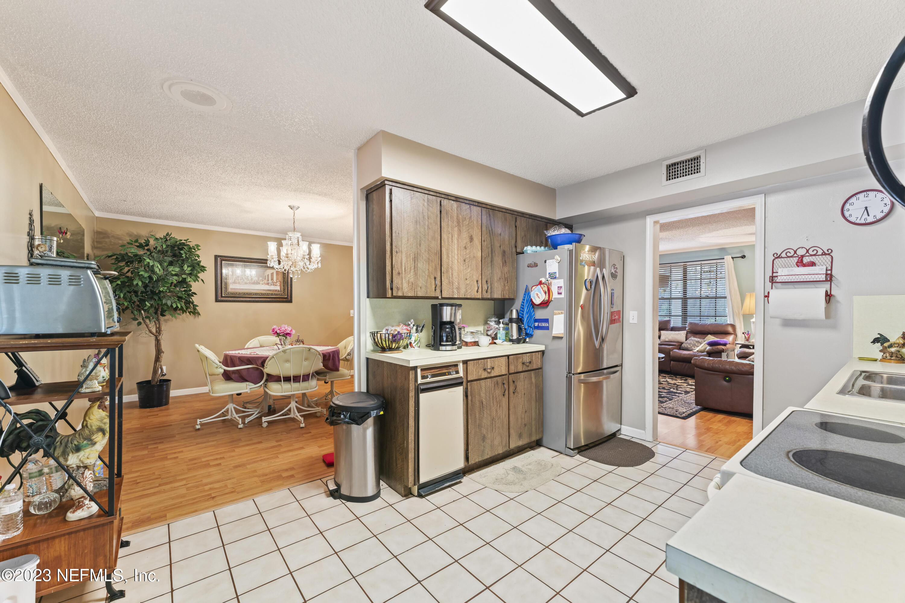 7349 Oakridge Loop Glen St. Mary, FL 32040 - Photo 21 of 56 a kitchen with a sink and a refrigerator