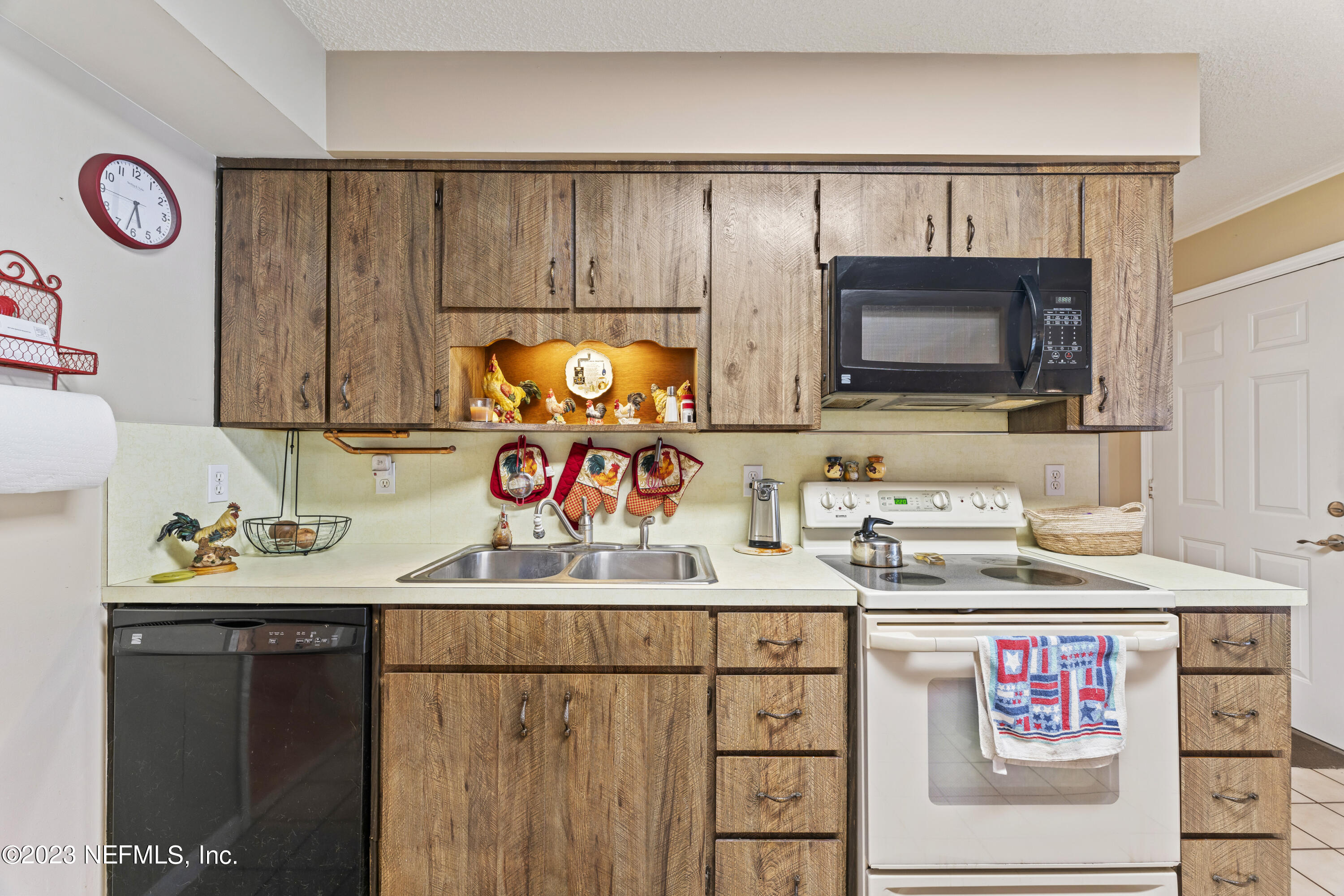 7349 Oakridge Loop Glen St. Mary, FL 32040 - Photo 22 of 56 a utility room with stainless steel appliances wooden cabinets and a microwave