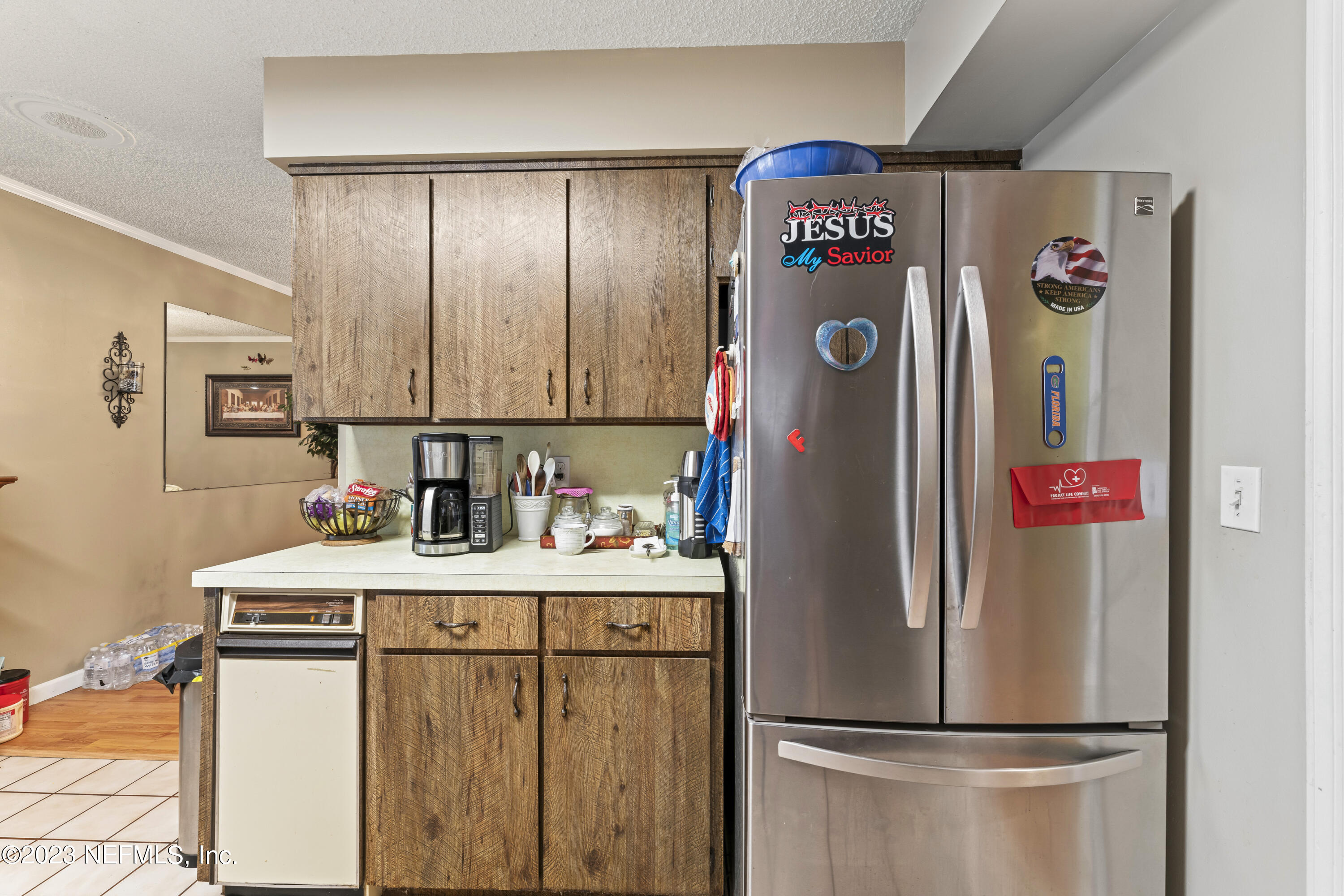 7349 Oakridge Loop Glen St. Mary, FL 32040 - Photo 23 of 56 a kitchen with refrigerator and washer
