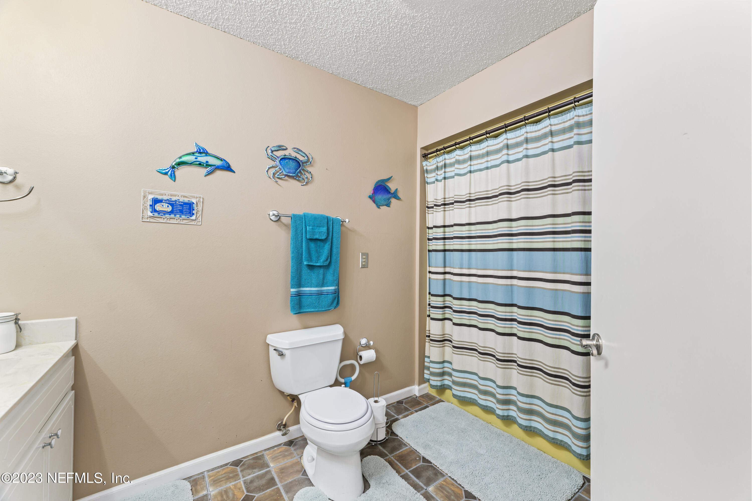 7349 Oakridge Loop Glen St. Mary, FL 32040 - Photo 29 of 56 a white toilet sitting next to a shower curtain