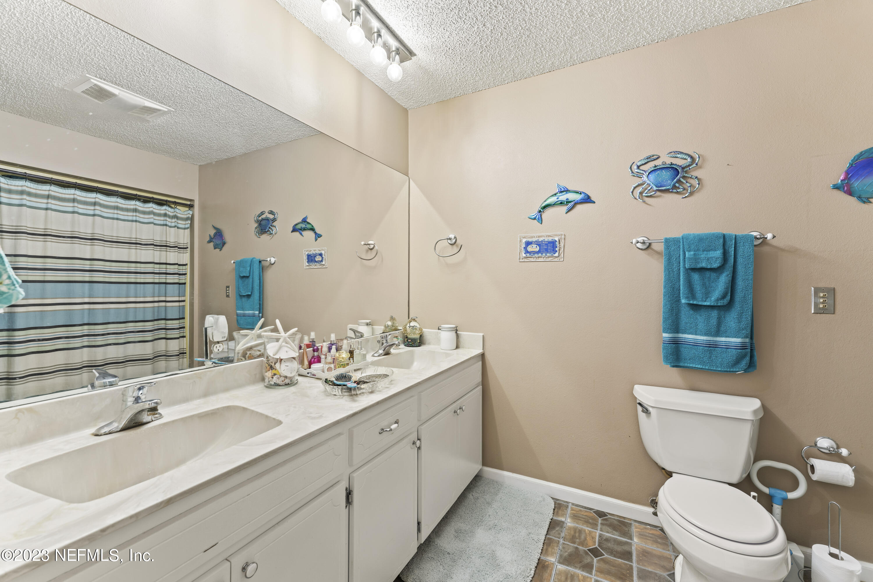 7349 Oakridge Loop Glen St. Mary, FL 32040 - Photo 30 of 56 a bathroom with a sink mirror vanity and toilet