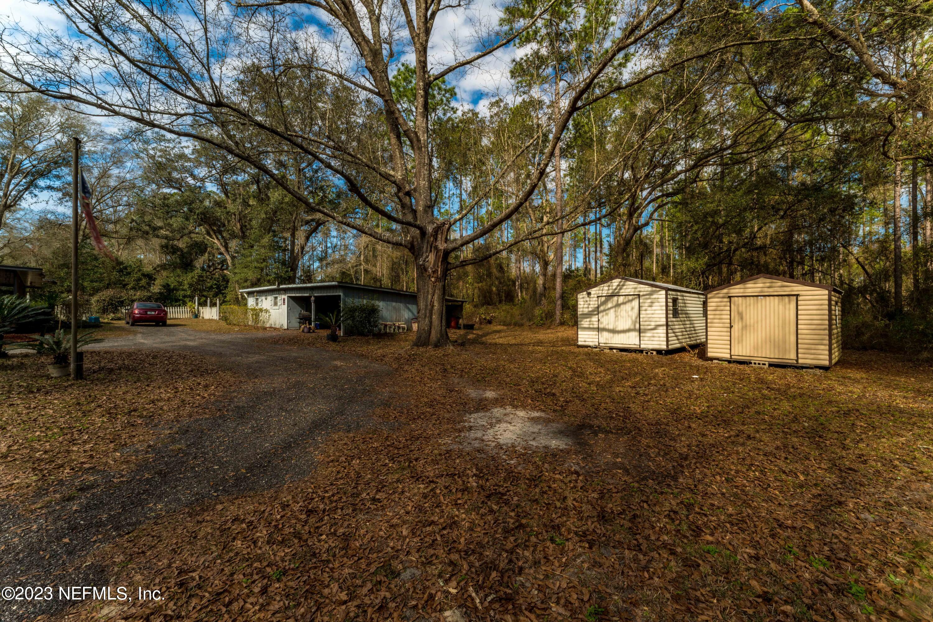7349 Oakridge Loop Glen St. Mary, FL 32040 - Photo 35 of 56 a view of a outdoor space with deck and tree