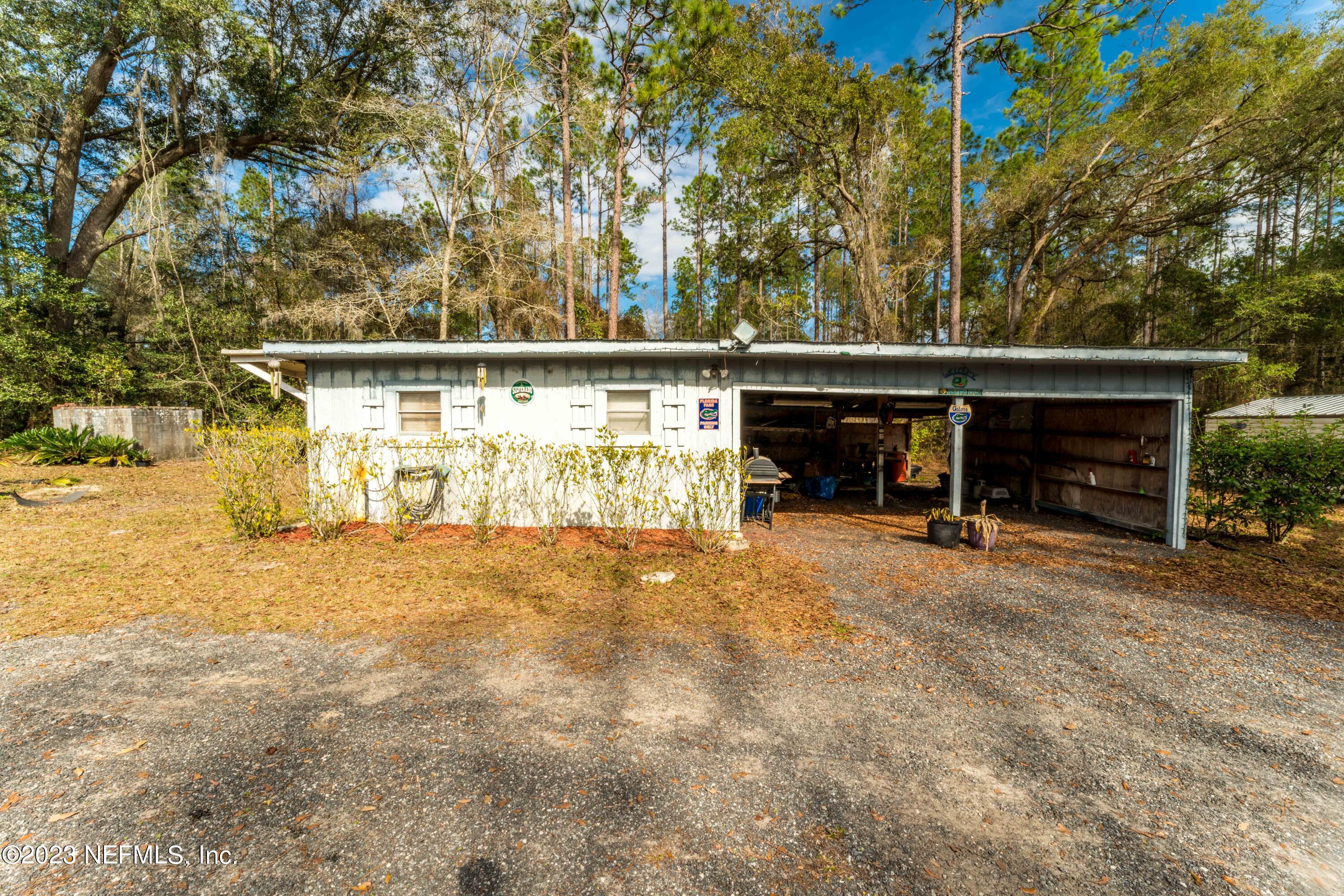 7349 Oakridge Loop Glen St. Mary, FL 32040 - Photo 37 of 56 a view of house with trees in the background