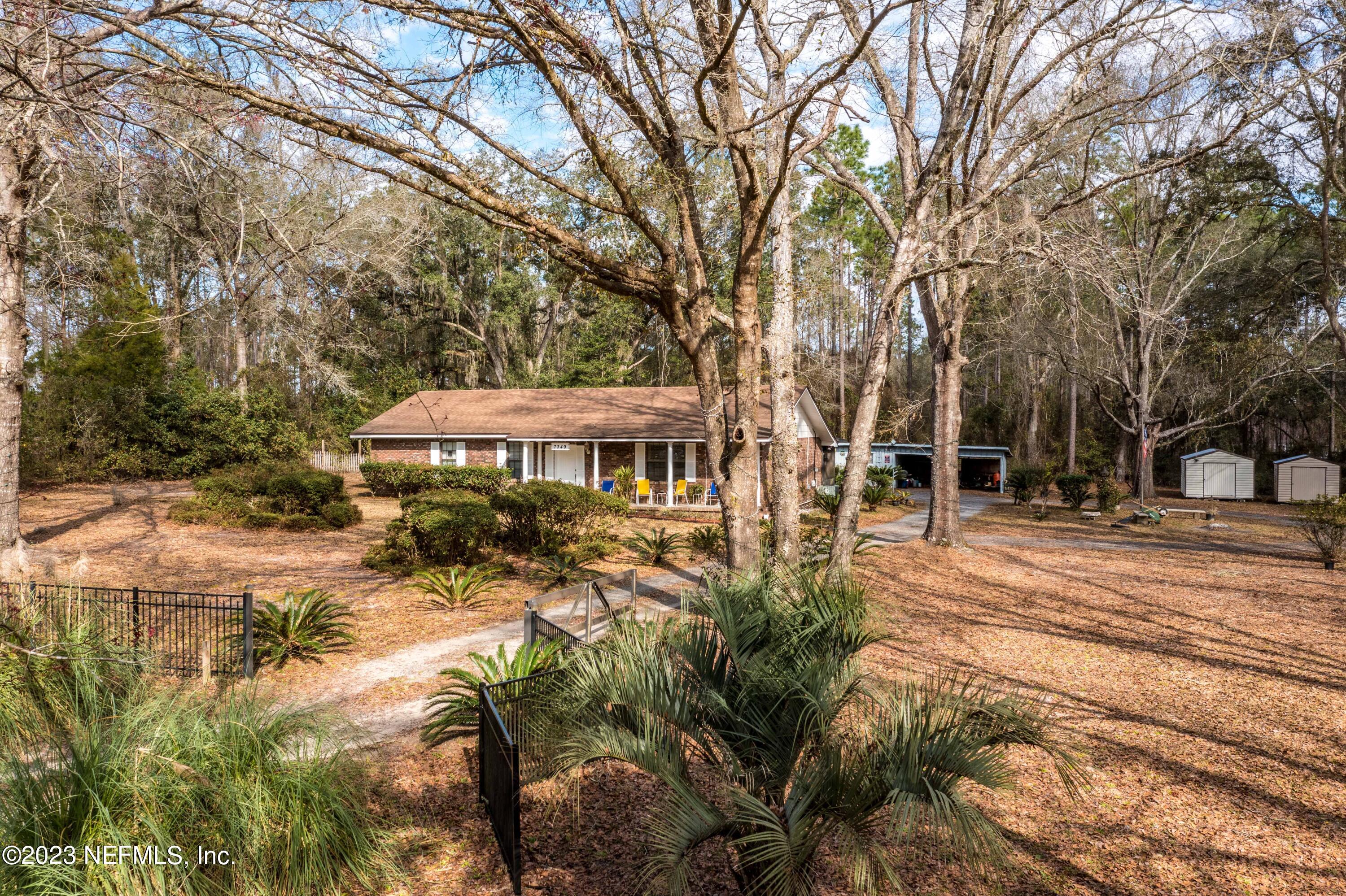 7349 Oakridge Loop Glen St. Mary, FL 32040 - Photo 47 of 56 a view of a house with backyard and sitting area