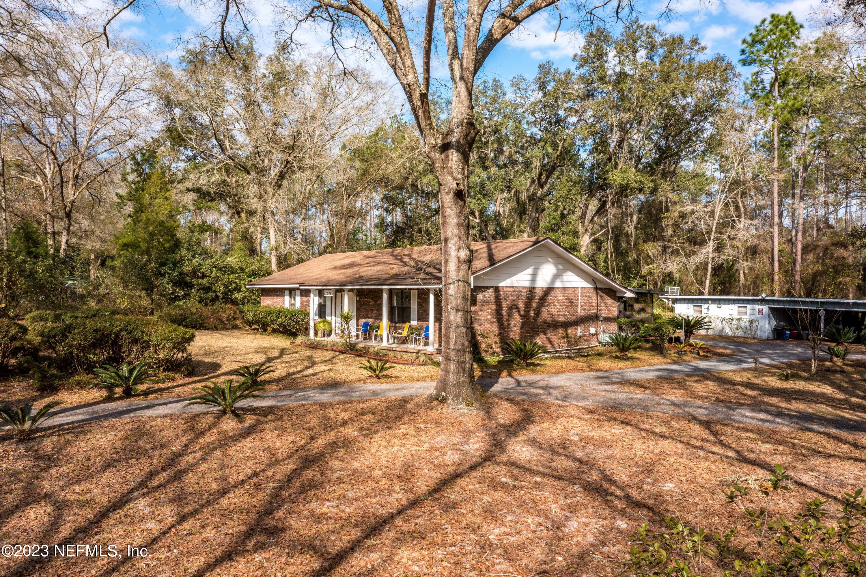 7349 Oakridge Loop Glen St. Mary, FL 32040 - Photo 48 of 56 a backyard of a house with barbeque oven