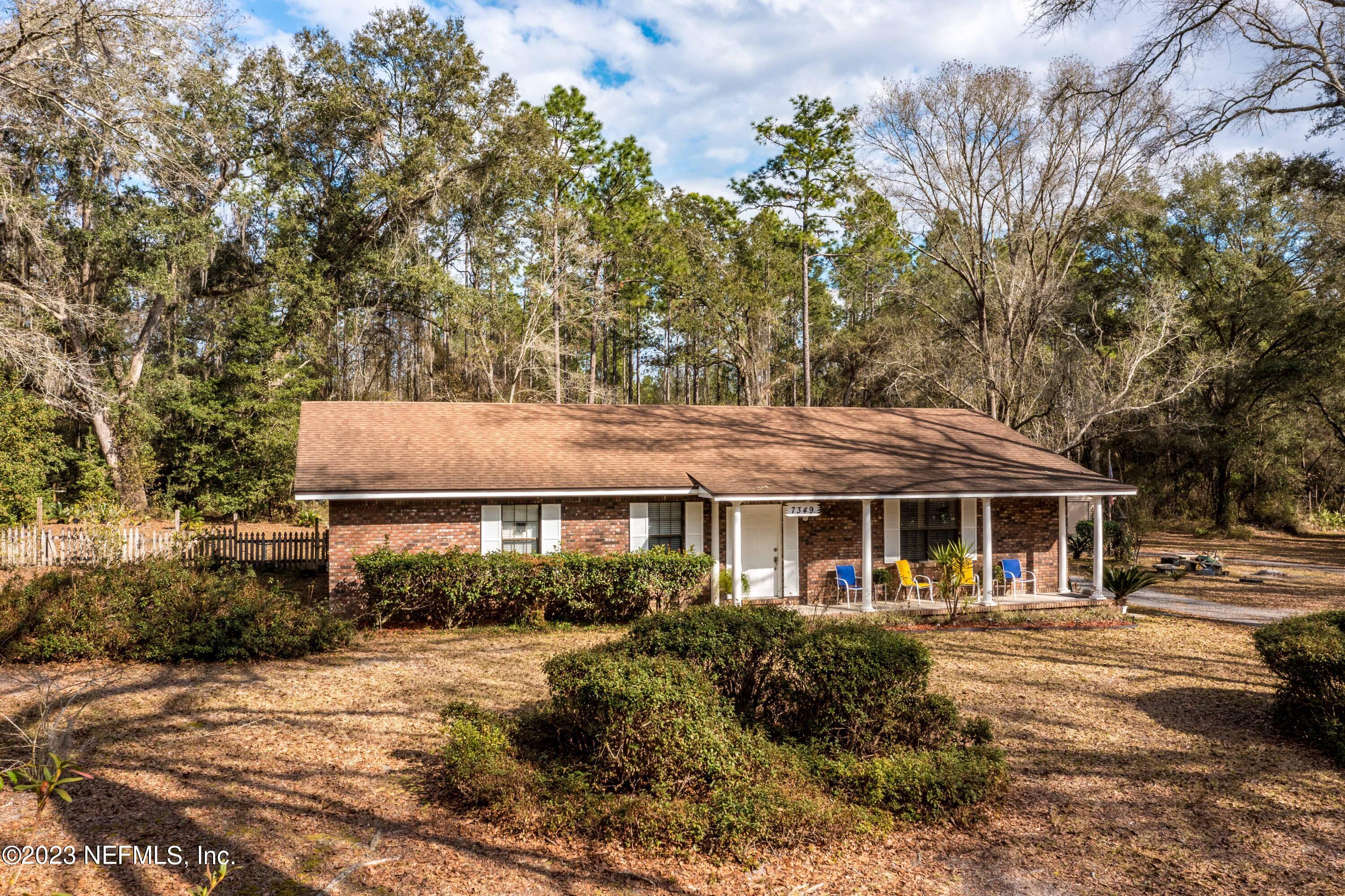 7349 Oakridge Loop Glen St. Mary, FL 32040 - Photo 51 of 56 a front view of a house with a yard tree and outdoor seating