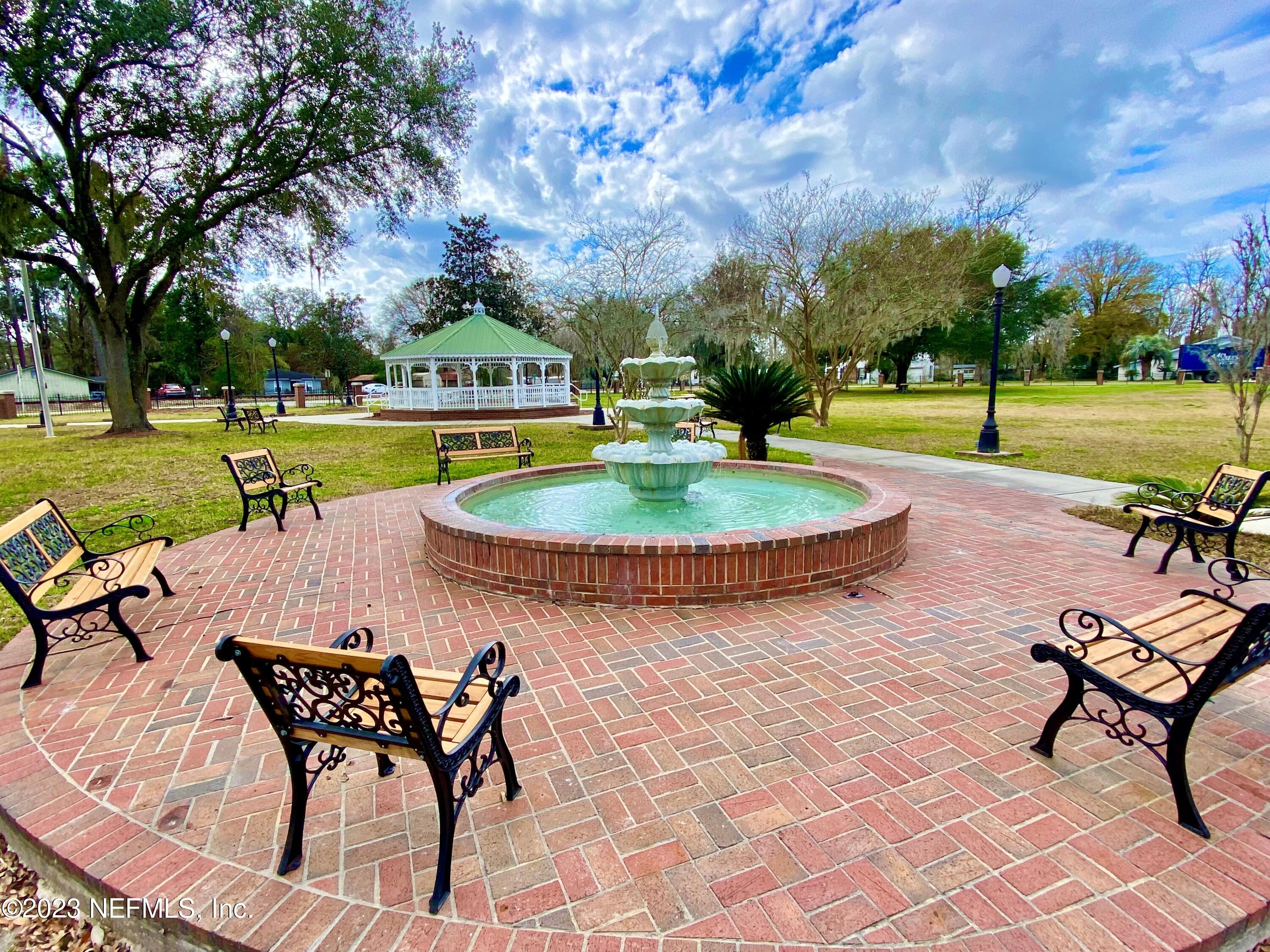 7349 Oakridge Loop Glen St. Mary, FL 32040 - Photo 52 of 56 a view of a swimming pool with a table and chairs