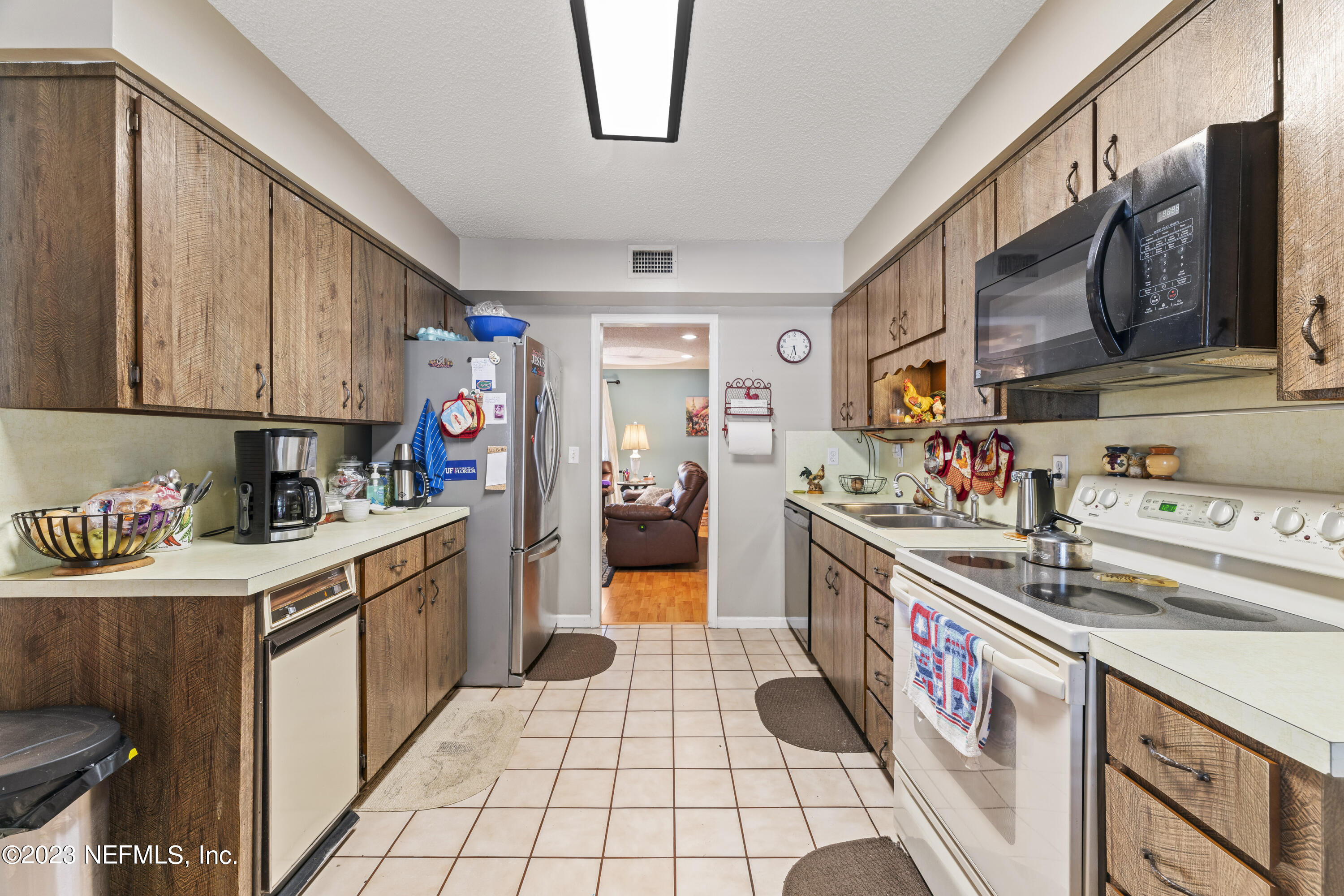 7349 Oakridge Loop Glen St. Mary, FL 32040 - Photo 9 of 56 a kitchen with stainless steel appliances granite countertop a sink and cabinets