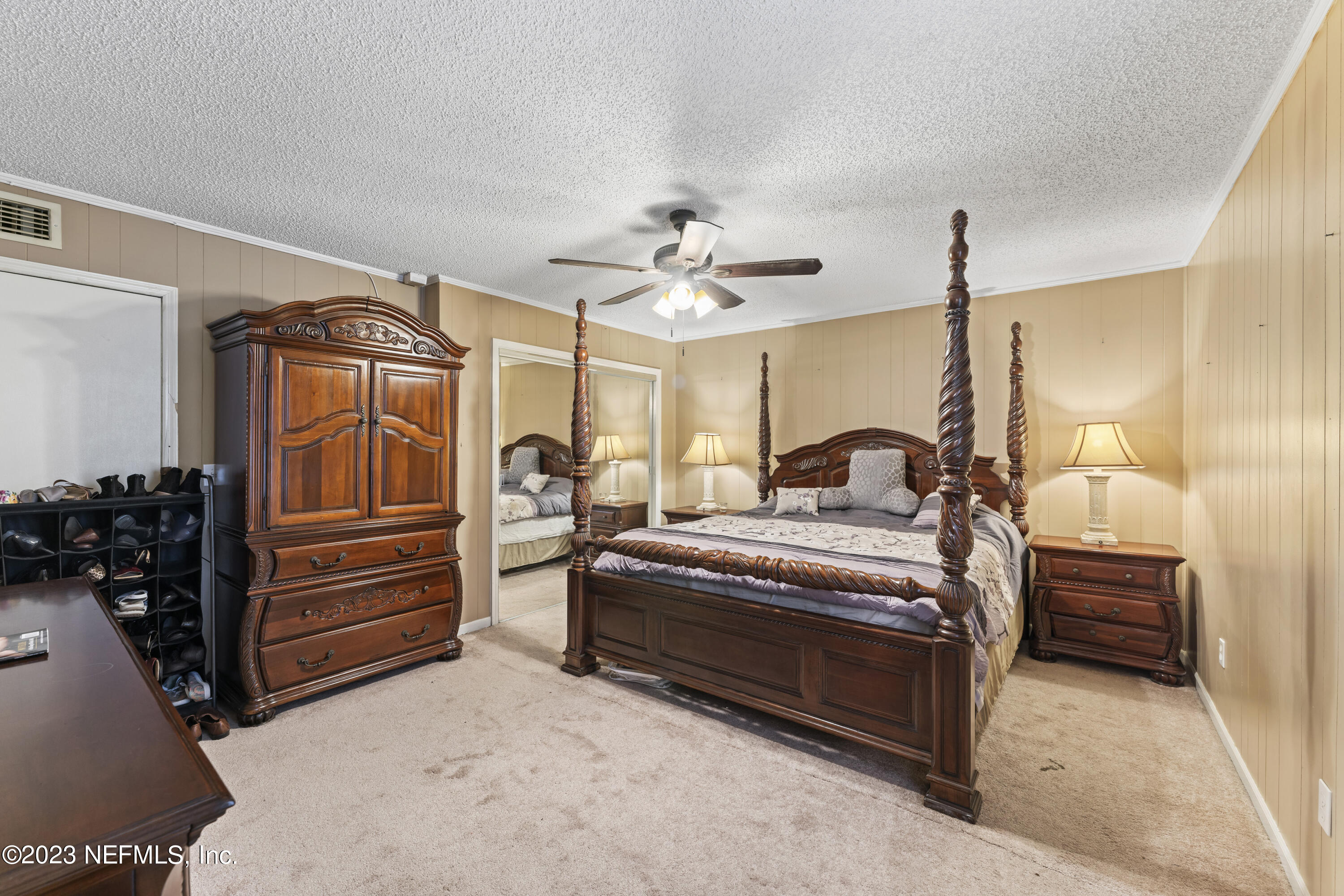 7349 Oakridge Loop Glen St. Mary, FL 32040 - Photo 10 of 56 a spacious bedroom with a bed and a chandelier