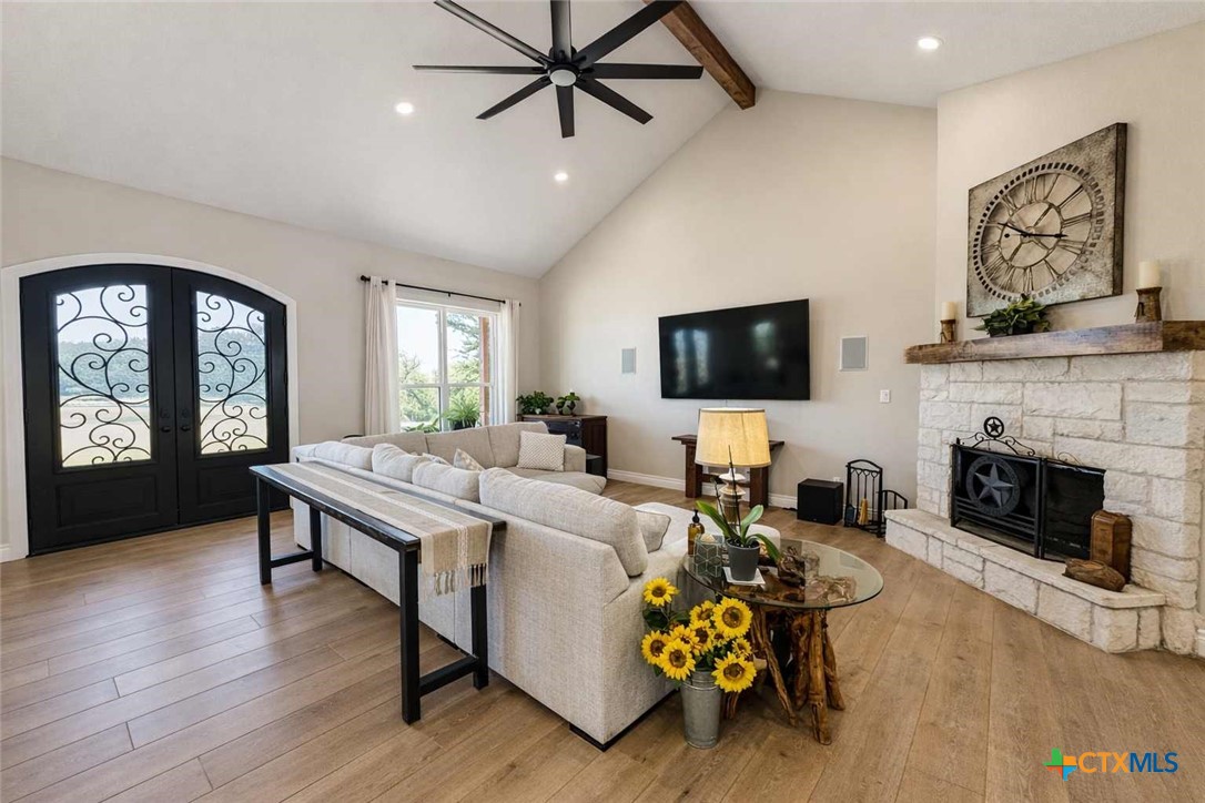 705 Indian Hills Road Gatesville, TX 76528 - Photo 11 of 43 a living room with furniture a fireplace and a flat screen tv