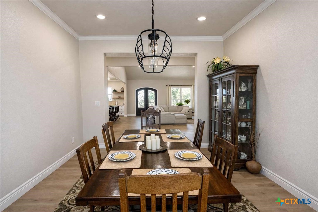 705 Indian Hills Road Gatesville, TX 76528 - Photo 18 of 43 a view of a dining room with furniture window and wooden floor