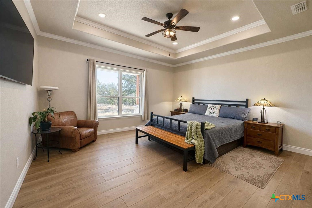 705 Indian Hills Road Gatesville, TX 76528 - Photo 19 of 43 a bedroom with a bed couch and window