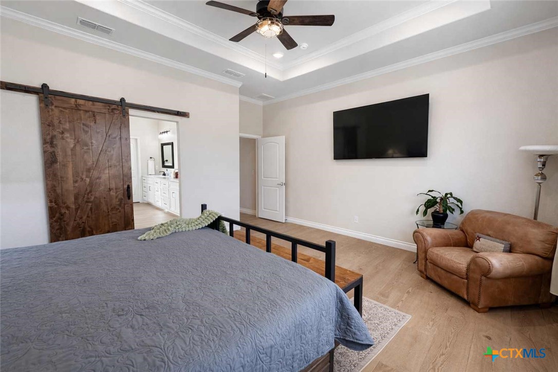 705 Indian Hills Road Gatesville, TX 76528 - Photo 20 of 43 a bedroom with a bed and a flat screen tv