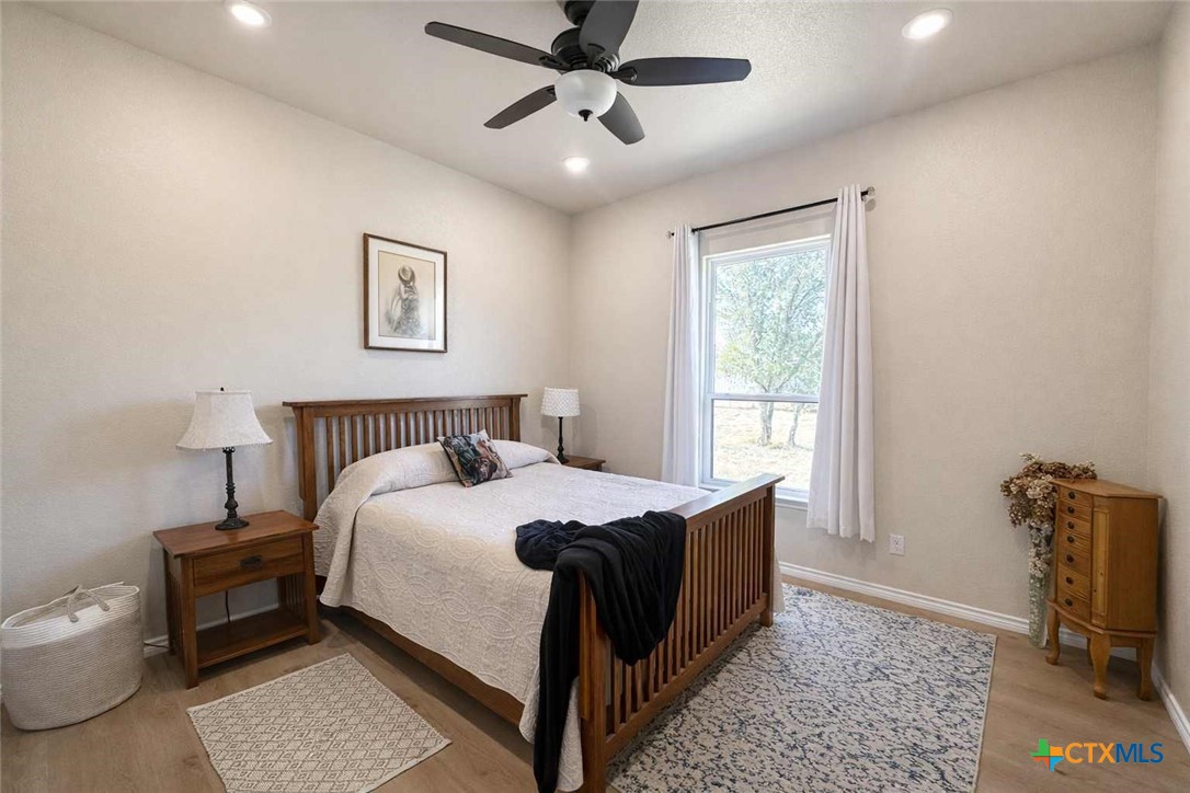 705 Indian Hills Road Gatesville, TX 76528 - Photo 26 of 43 a bedroom with a bed and a chandelier