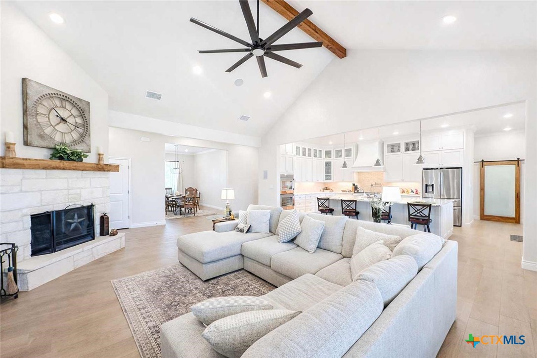 705 Indian Hills Road Gatesville, TX 76528 - Photo 10 of 43 a living room with furniture a fireplace and a chandelier
