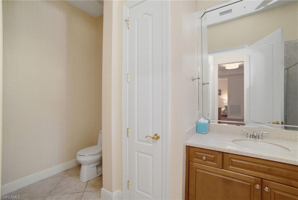 17015 Porta Vecchio Way, Unit 101 Naples, FL 34110 - Photo 17 of 39 a bathroom with a sink a toilet and shower