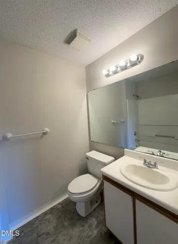 a bathroom with a sink a toilet and mirror