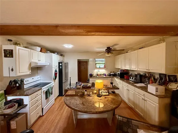 a kitchen with stainless steel appliances granite countertop a sink stove and cabinets