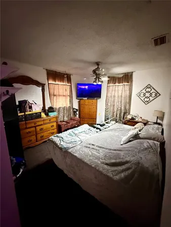a bed sitting in a bedroom next to a window