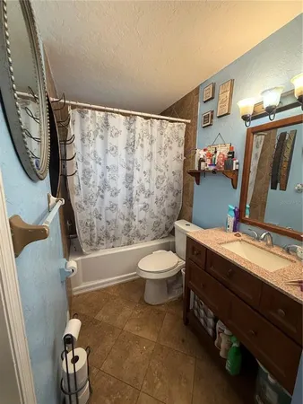 a bathroom with a toilet a sink and a mirror