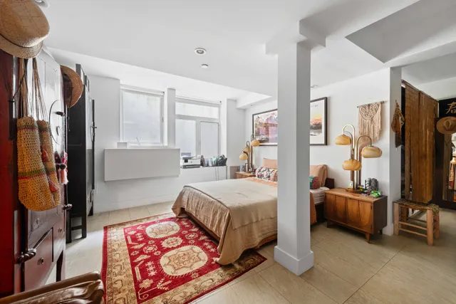 a bedroom with furniture and a flat screen tv