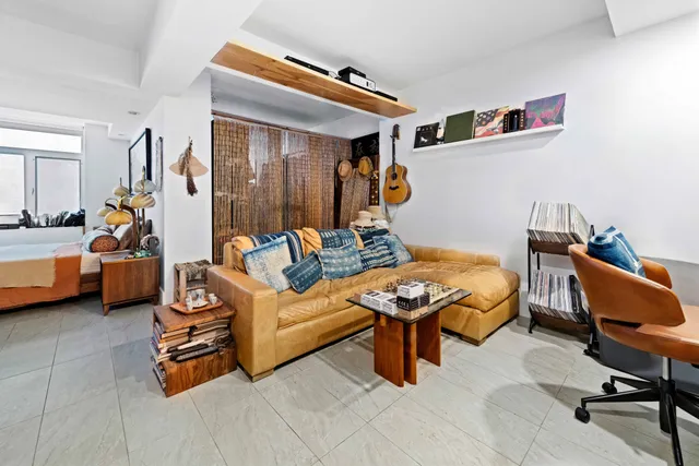 a bedroom with furniture and a rug