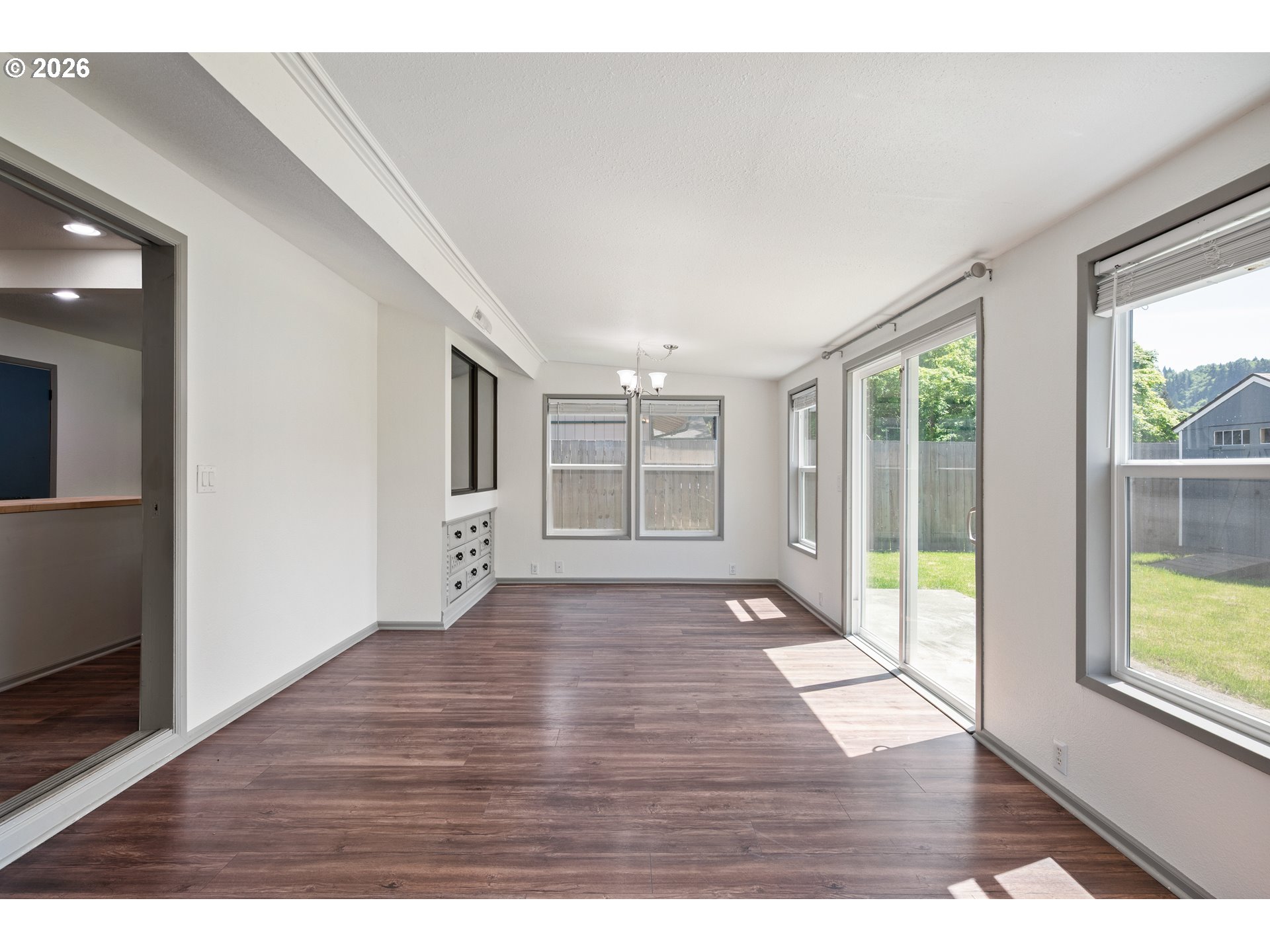 4703 Merlin Street Longview, WA 98632 - Photo 12 of 25 a view of an empty room with wooden floor and a window