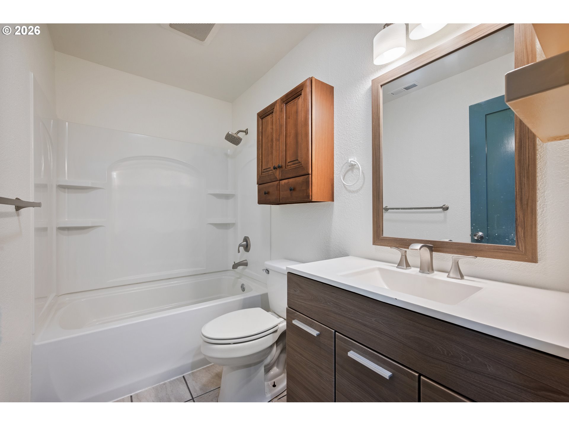 4703 Merlin Street Longview, WA 98632 - Photo 14 of 25 a bathroom with a sink a toilet a mirror and shower