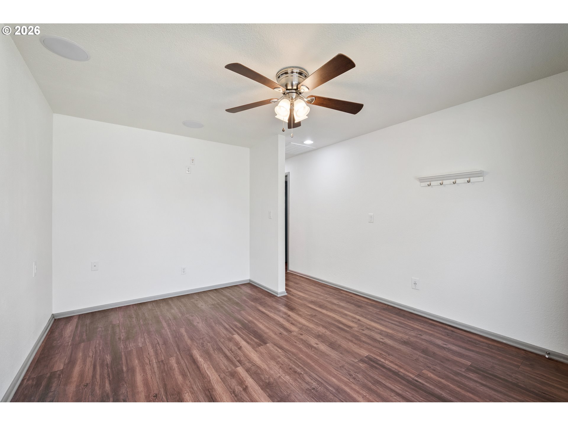 4703 Merlin Street Longview, WA 98632 - Photo 6 of 25 a view of an empty room with wooden floor