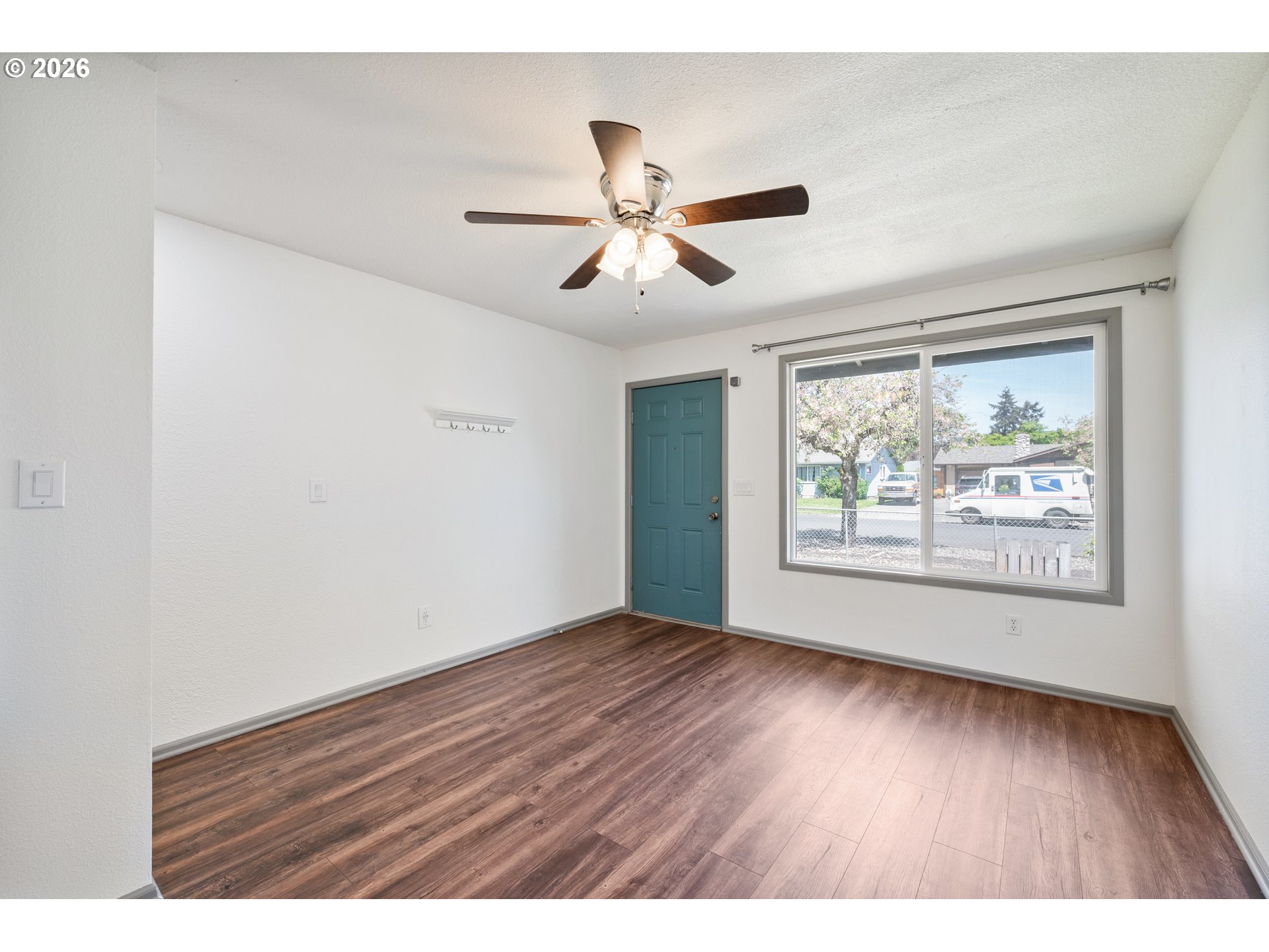 4703 Merlin Street Longview, WA 98632 - Photo 8 of 25 a view of an empty room with window and wooden floor