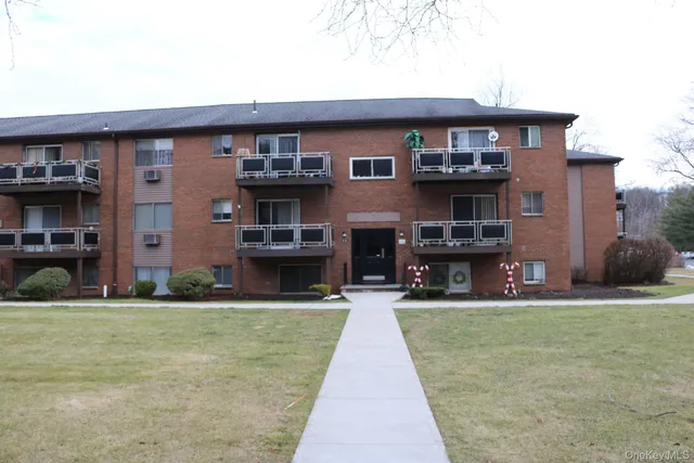 a front view of a building with a yard