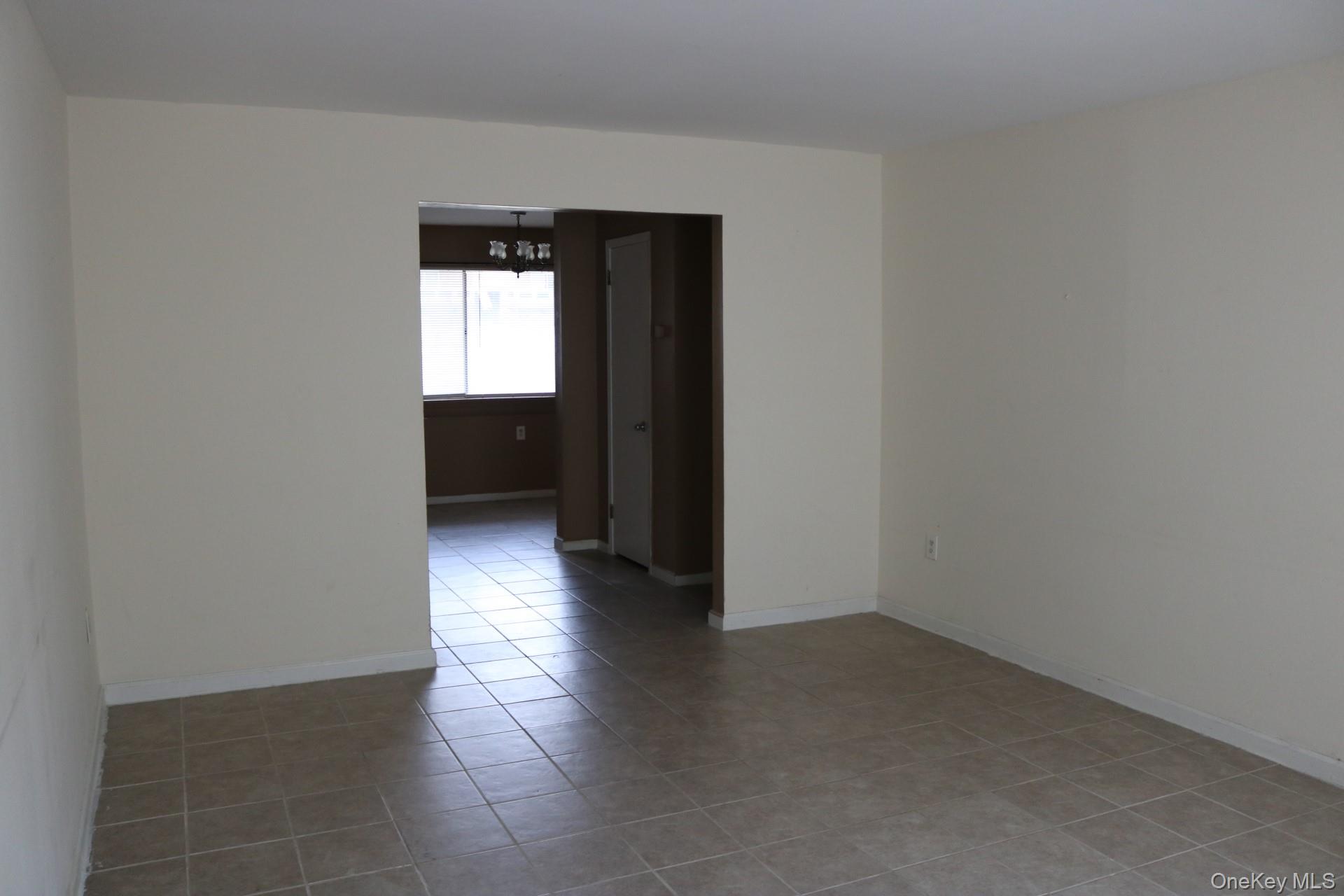 33 Tanager Road, Unit 3301 Monroe, NY 10950 - Photo 5 of 15 a view of an empty room with wooden floor and a window