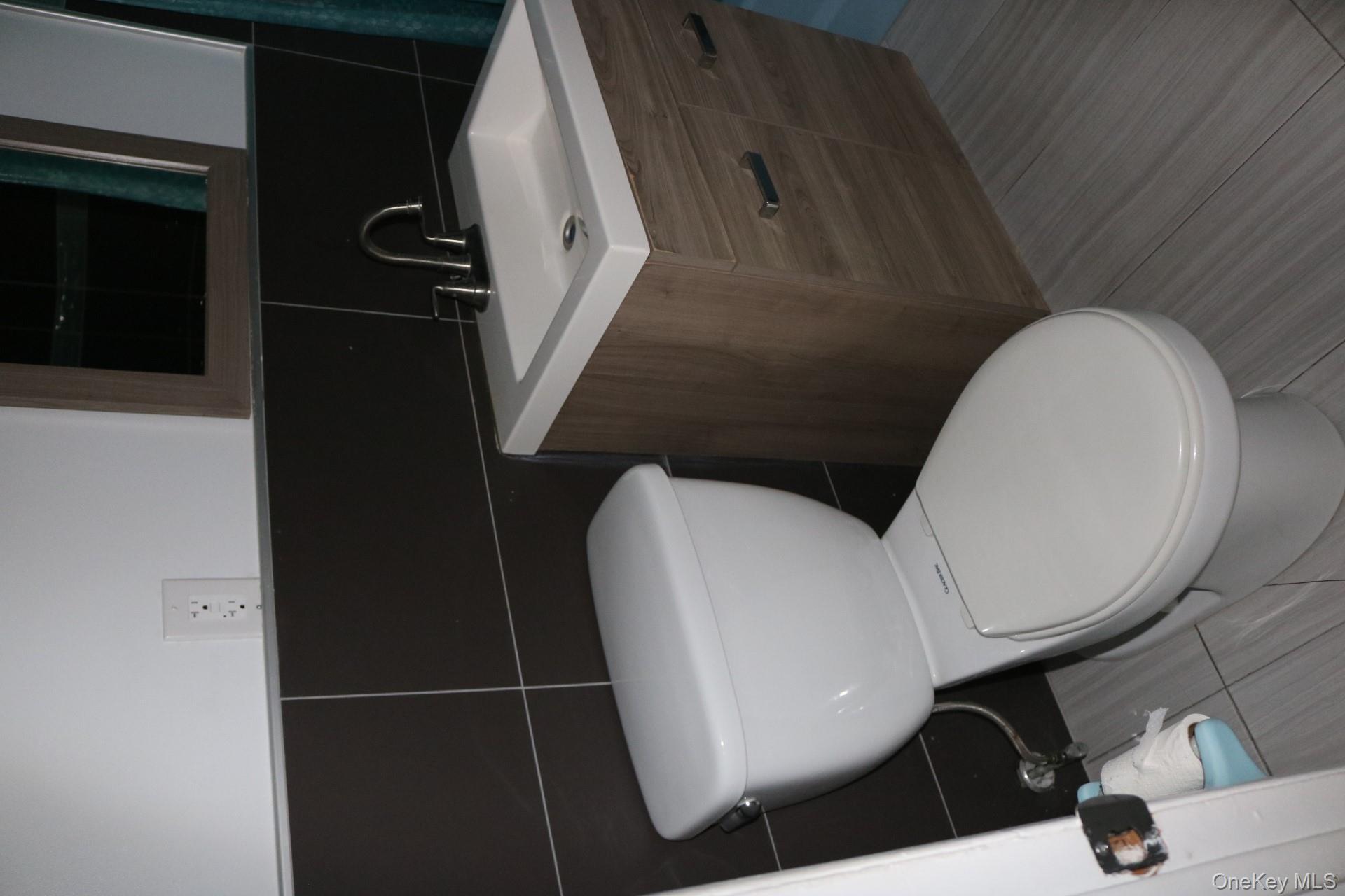 33 Tanager Road, Unit 3301 Monroe, NY 10950 - Photo 9 of 15 a bathroom with a toilet sink and mirror