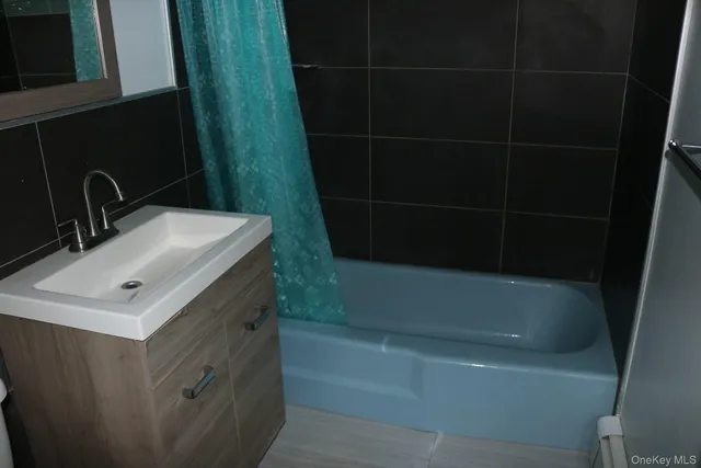 a bathroom with a sink a toilet and bathtub