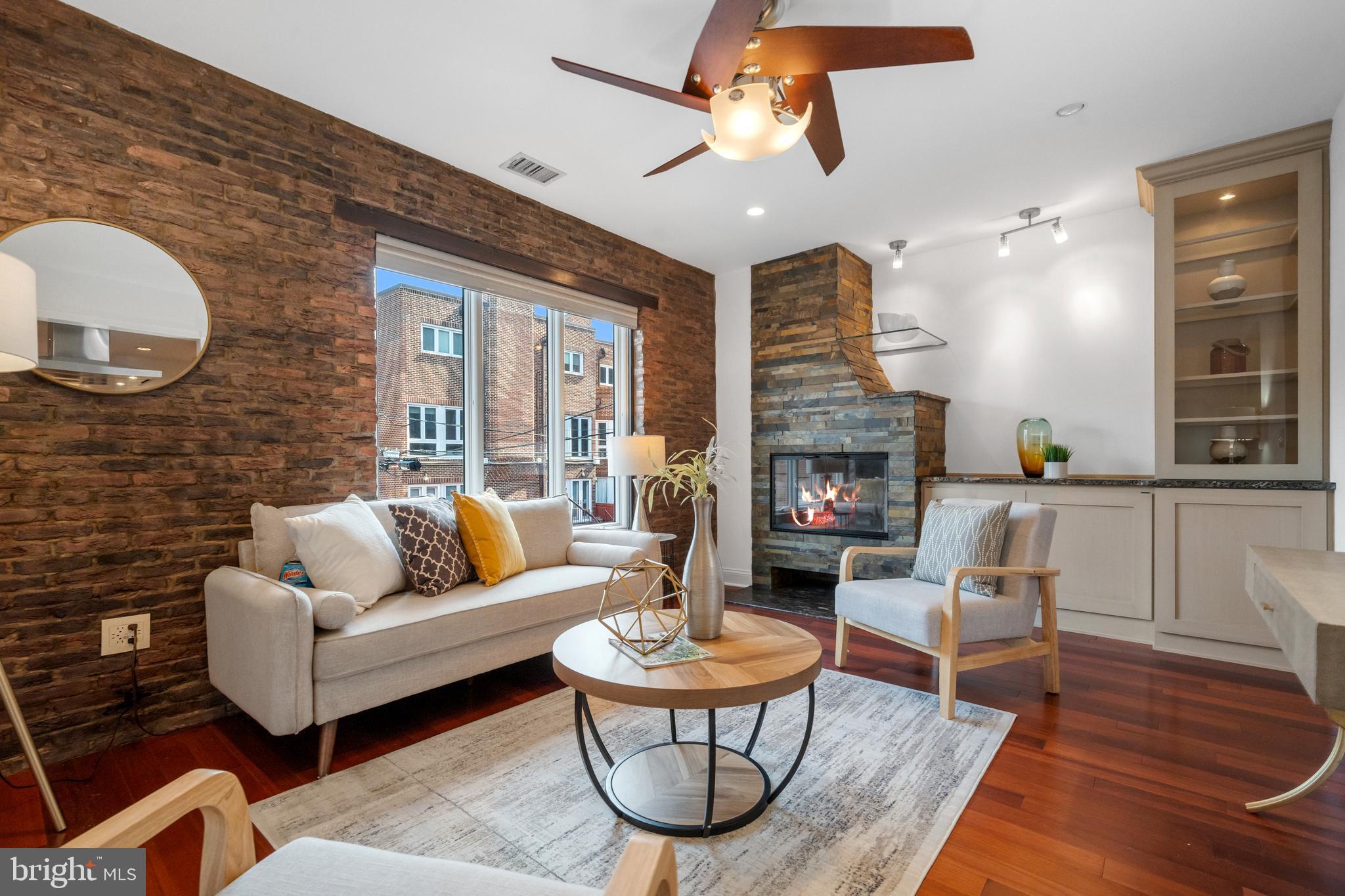 a living room with furniture a fireplace and a chandelier