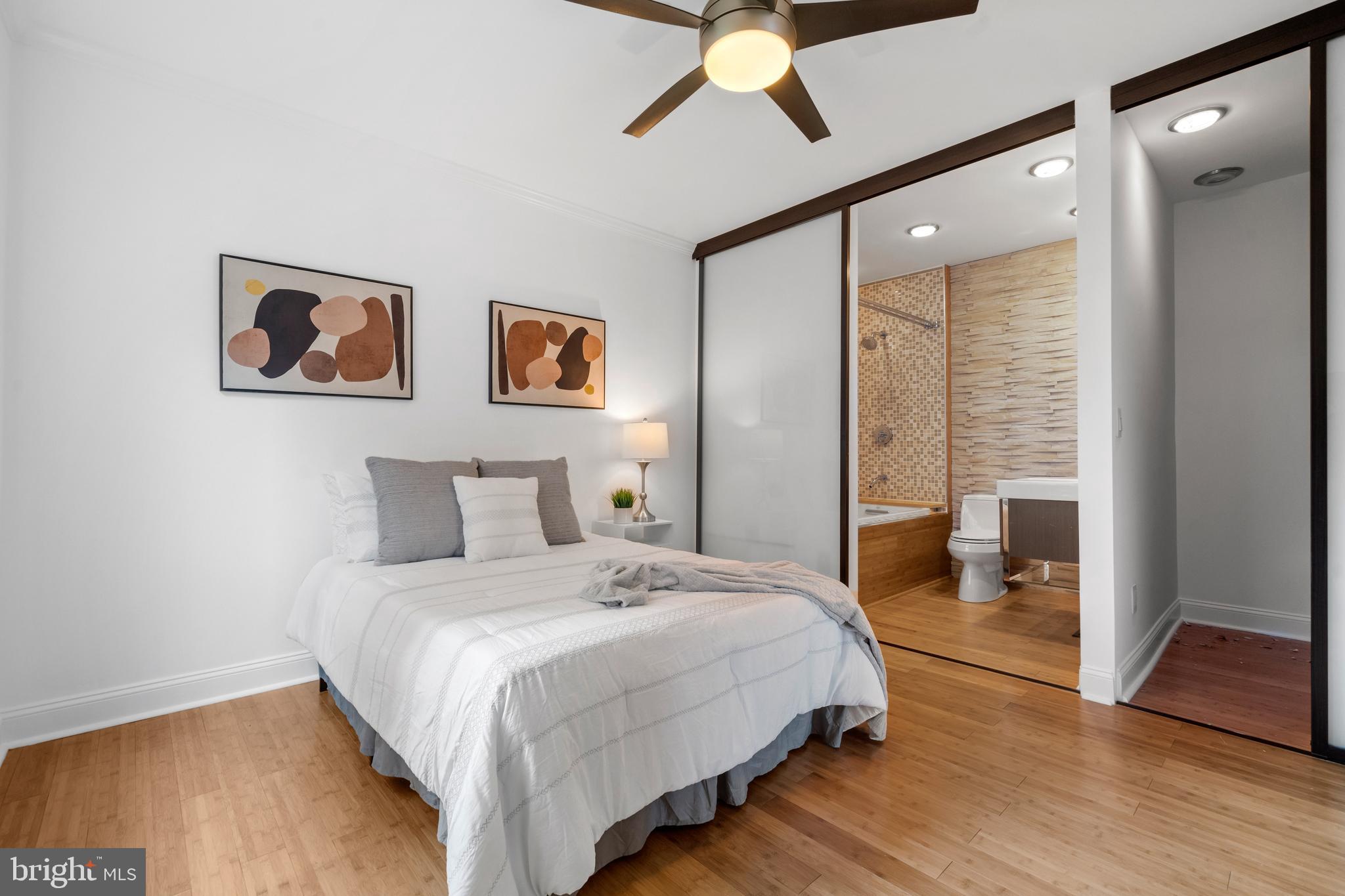 1625 Q Street Northwest, Unit 203 Washington, DC 20009 - Photo 23 of 33 a bedroom with bed and a chandelier