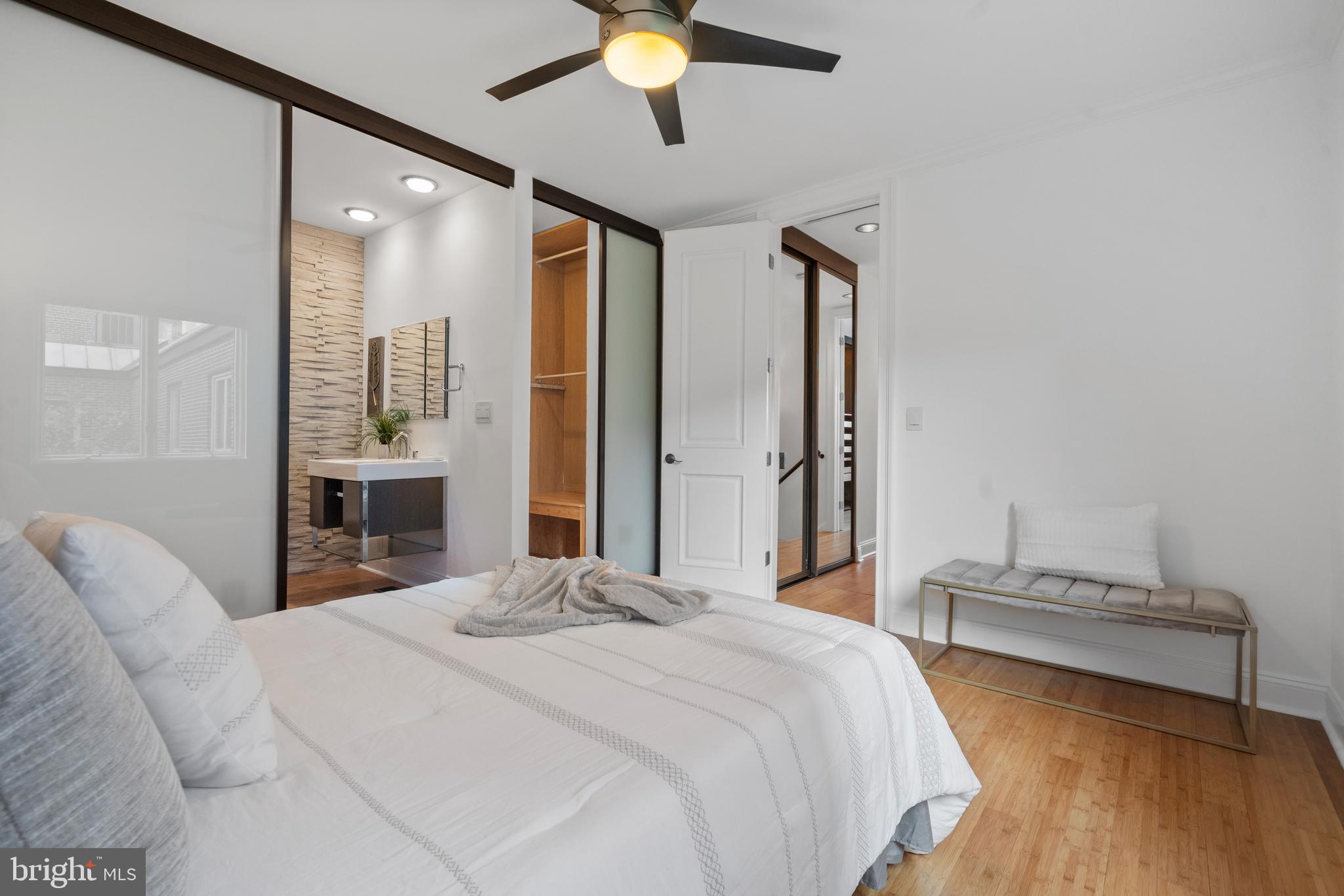 1625 Q Street Northwest, Unit 203 Washington, DC 20009 - Photo 24 of 33 a bedroom with a large bed and a chandelier