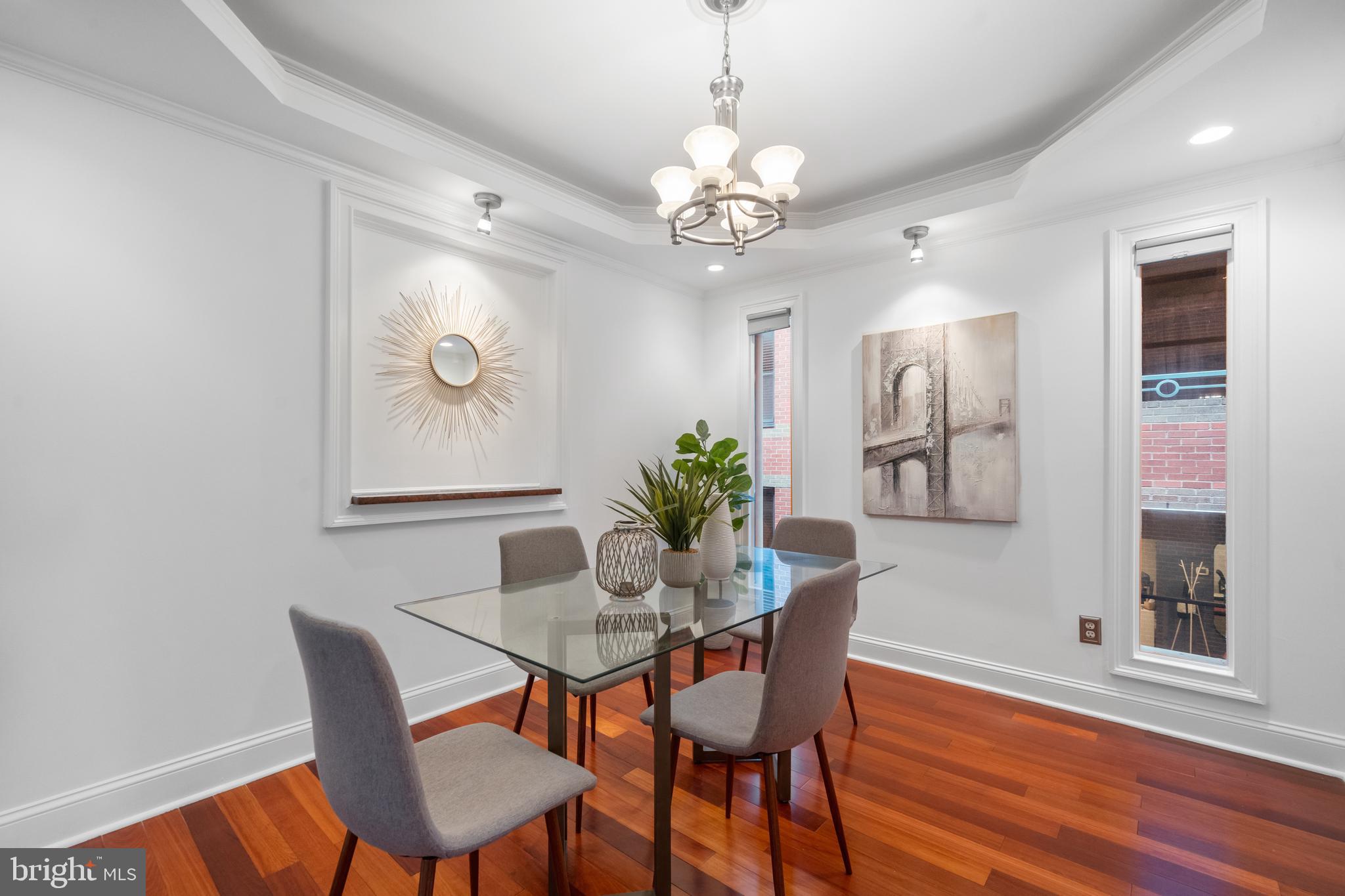 1625 Q Street Northwest, Unit 203 Washington, DC 20009 - Photo 8 of 33 a dining room with furniture a chandelier and wooden floor