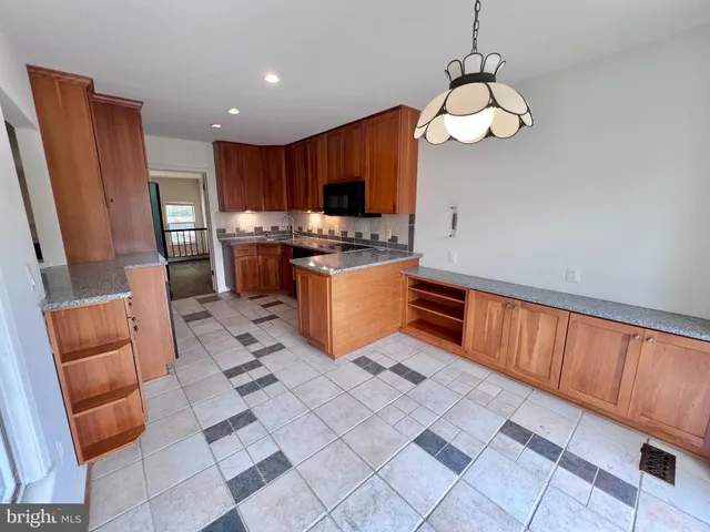 a kitchen with stainless steel appliances granite countertop a refrigerator a stove top oven a sink and dishwasher