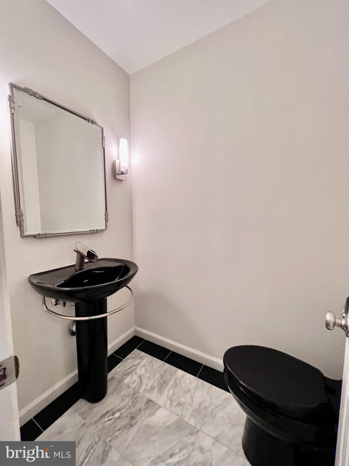 1445 Hampton Hill Circle McLean, VA 22101 - Photo 18 of 36 a bathroom with a sink a toilet and mirror